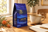 Marnka & Co. Wadhlu Blend bag beside a cup of coffee and an open notebook with grevillea